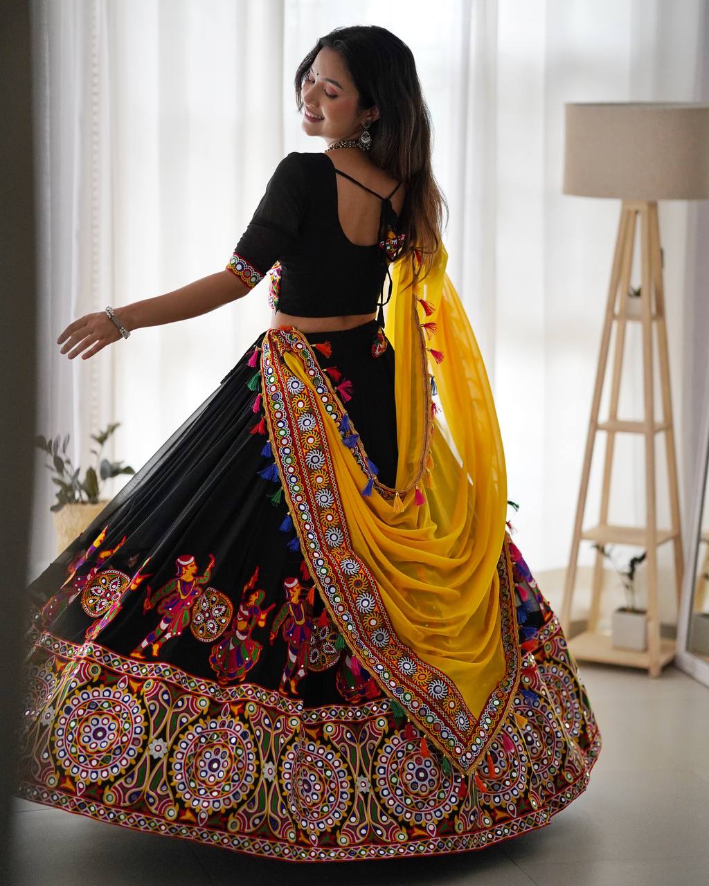 Black Navratri Lehenga Choli Set With Gujarati Embroidery and traditional Garba Dancer Motifs With Yellow Dupatta