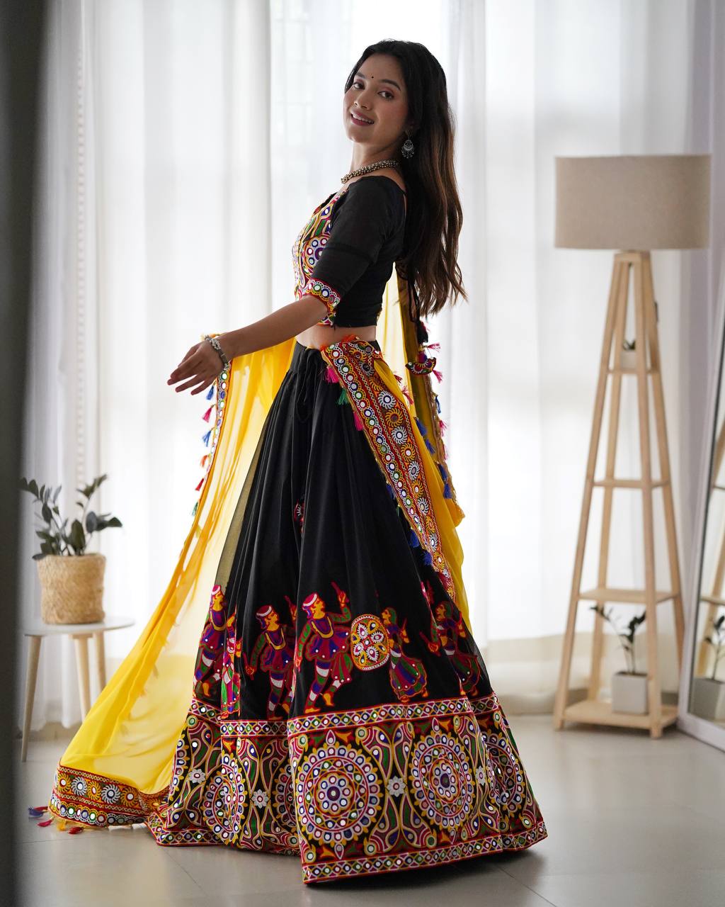 Black Navratri Lehenga Choli Set With Gujarati Embroidery and traditional Garba Dancer Motifs With Yellow Dupatta